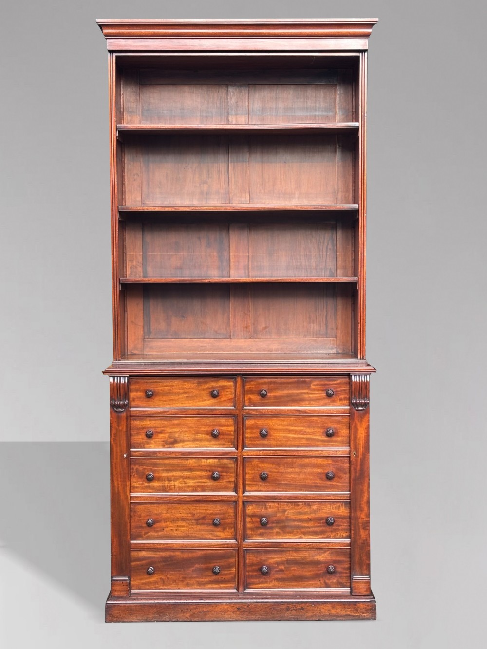A nineteenth-century mahogany open library bookcase featuring a Wellington chest base with ten small drawers and open adjustable upper shelves. View III