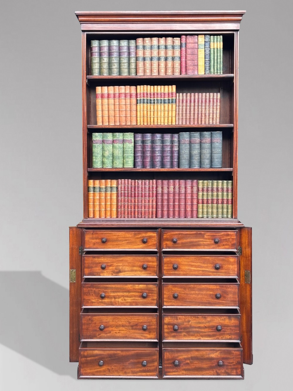 A nineteenth-century mahogany open library bookcase featuring a Wellington chest base with ten small drawers and open adjustable upper shelves. View V