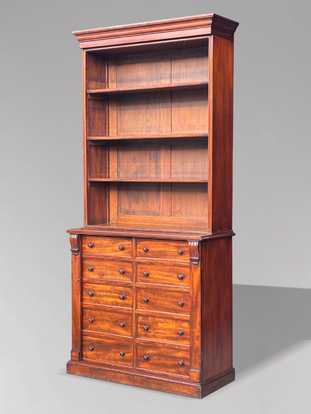 A nineteenth-century mahogany open library bookcase featuring a Wellington chest base with ten small drawers and open adjustable upper shelves. View VI