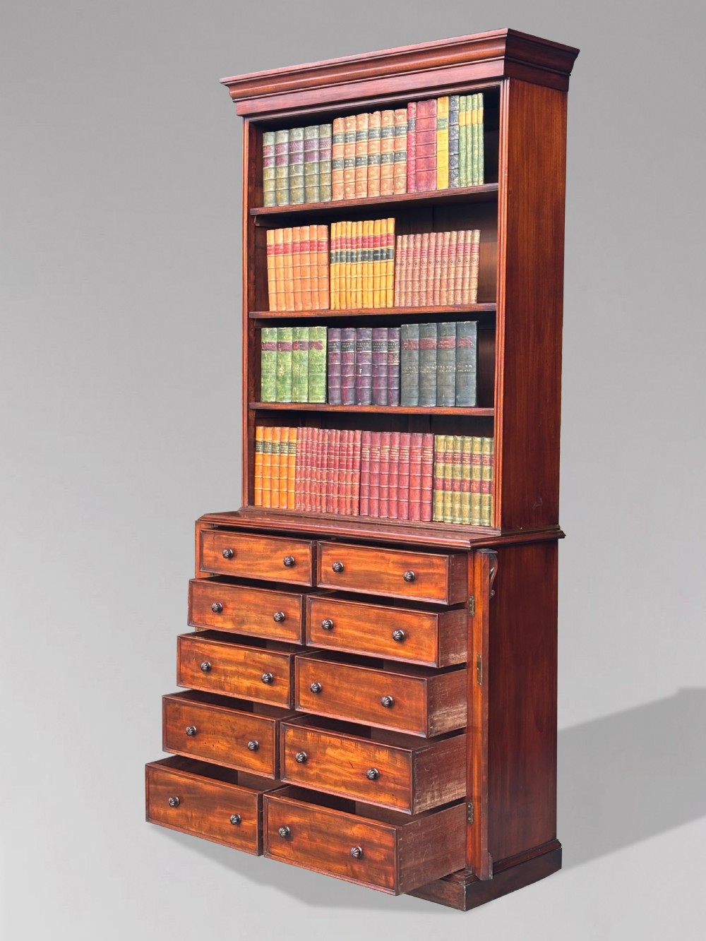 A nineteenth-century mahogany open library bookcase featuring a Wellington chest base with ten small drawers and open adjustable upper shelves. View VII