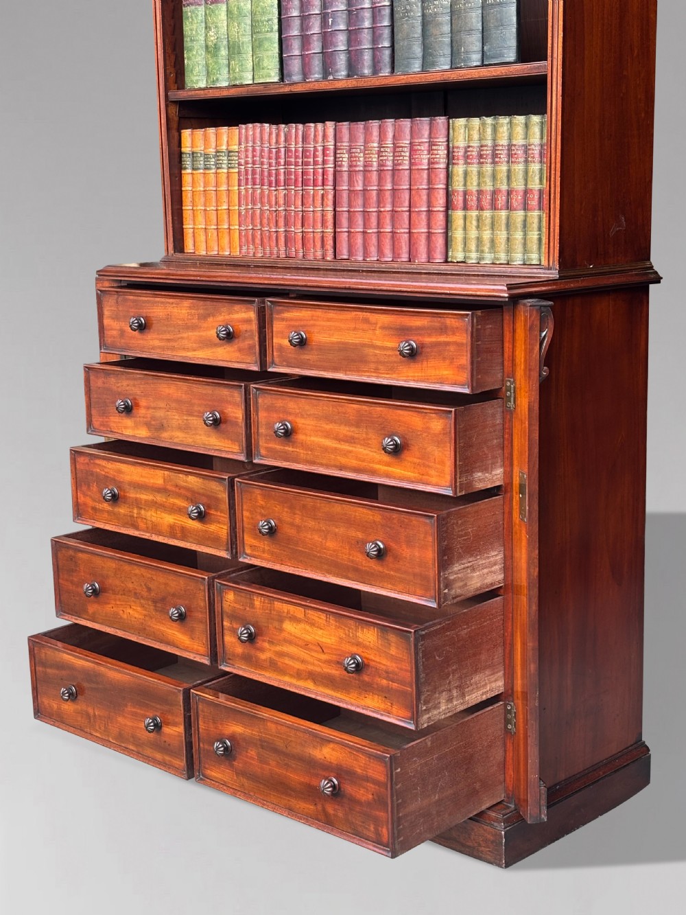 A nineteenth-century mahogany open library bookcase featuring a Wellington chest base with ten small drawers and open adjustable upper shelves. View VIII