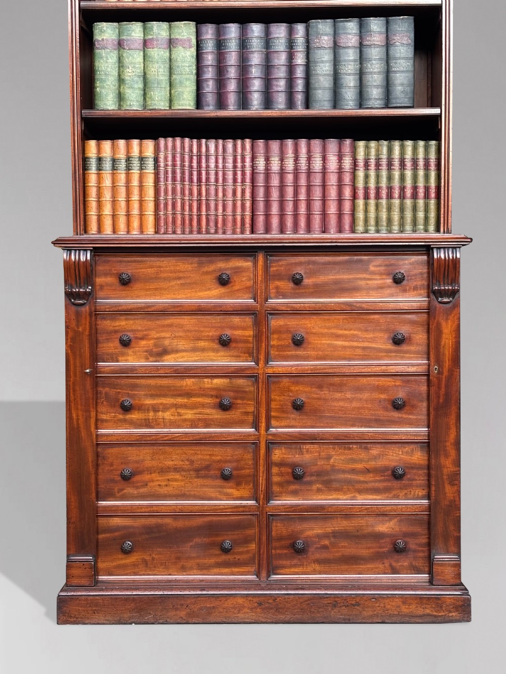 A nineteenth-century mahogany open library bookcase featuring a Wellington chest base with ten small drawers and open adjustable upper shelves. View XV