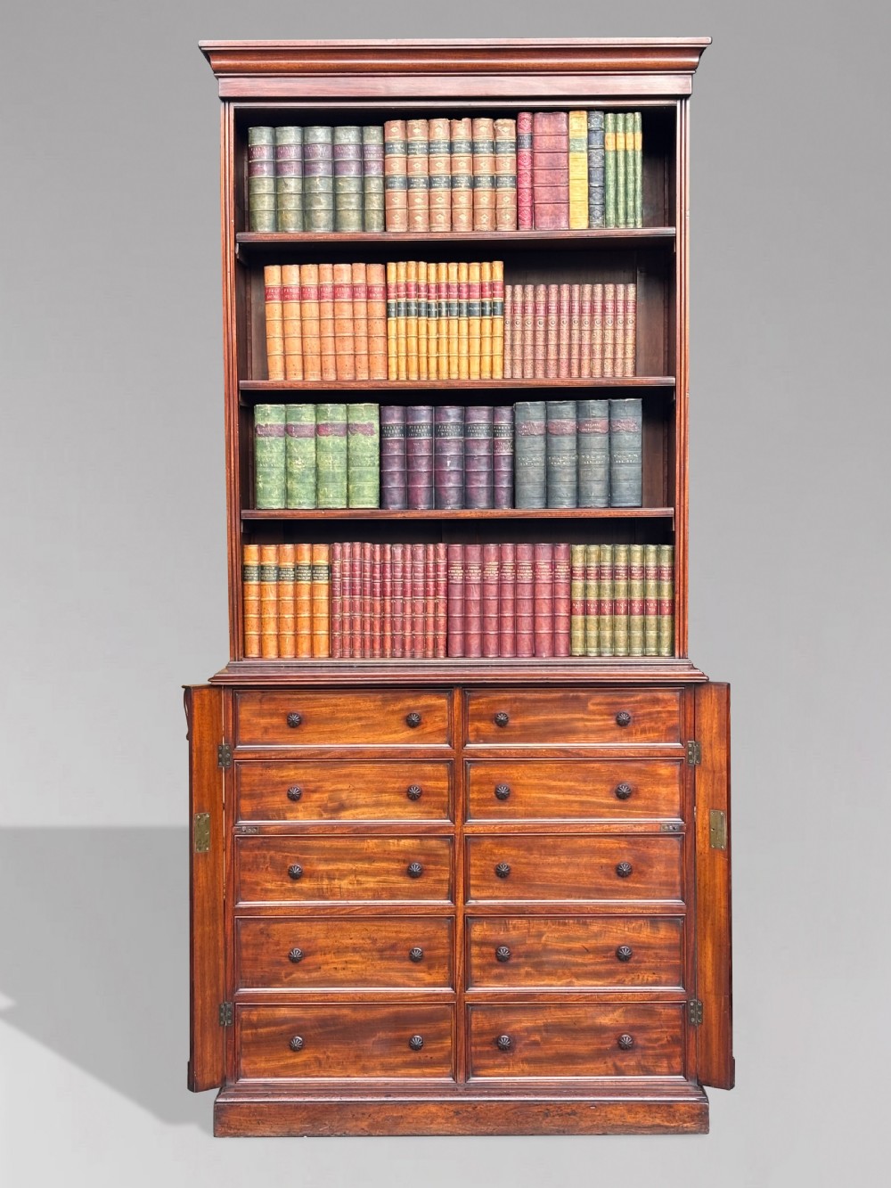 A nineteenth-century mahogany open library bookcase featuring a Wellington chest base with ten small drawers and open adjustable upper shelves. View XVI