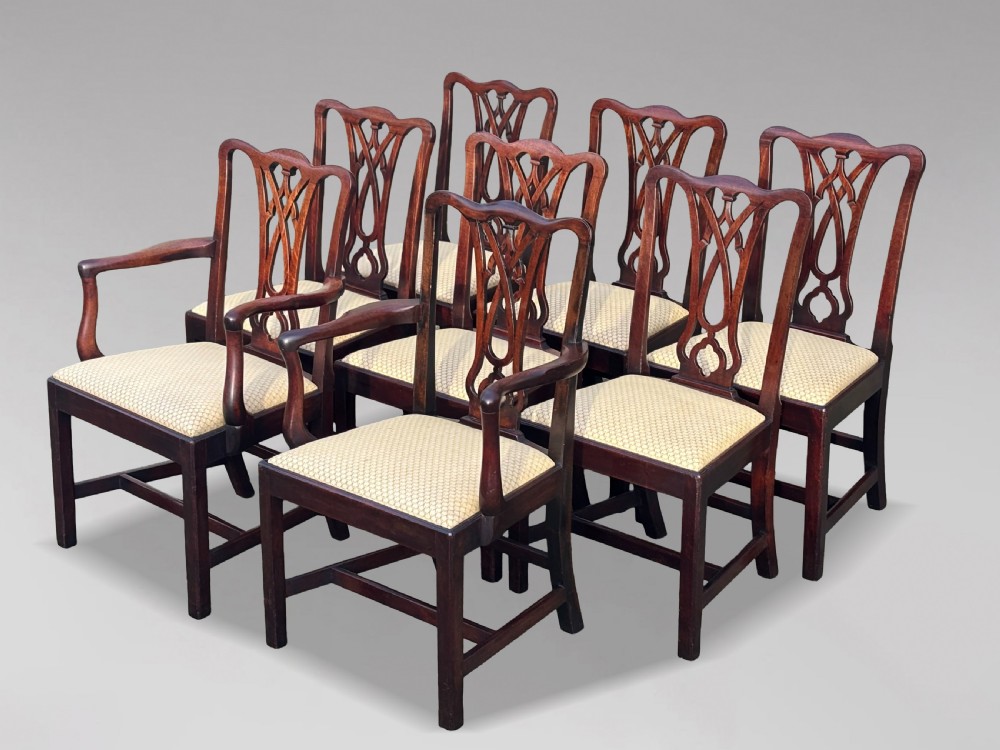 A set of eight George IV mahogany dining chairs with pierced fretwork splats and light cream upholstered drop-in seats.