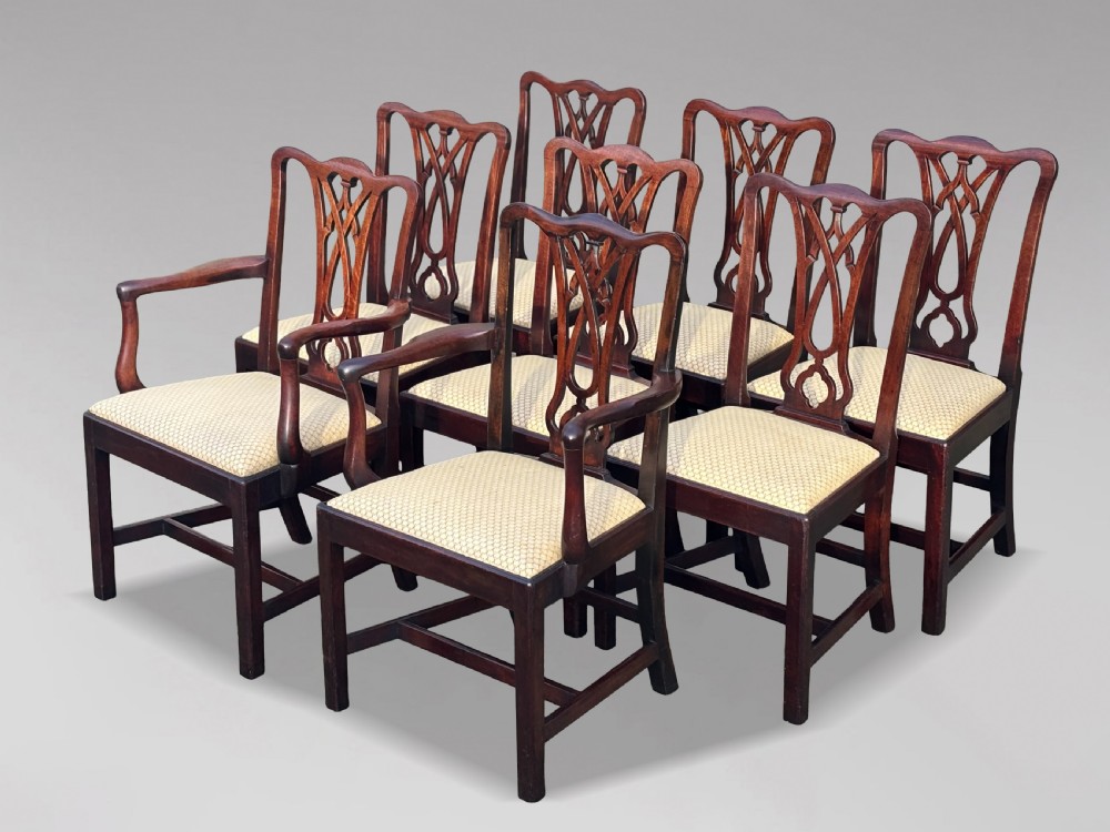 A set of eight George IV mahogany dining chairs with pierced fretwork splats and light cream upholstered drop-in seats. View II