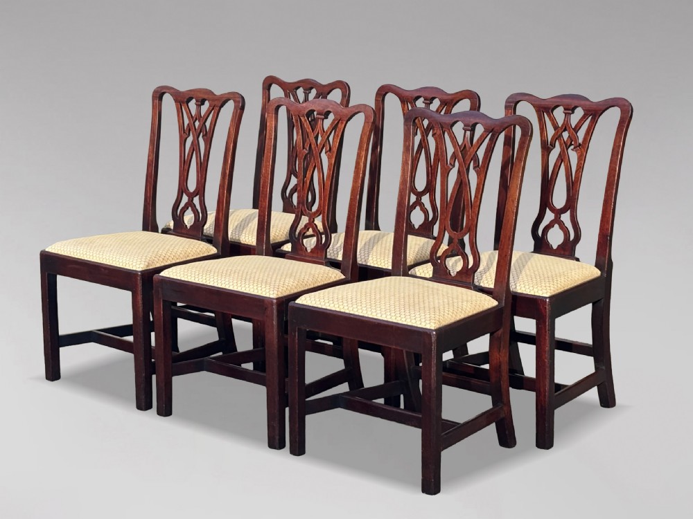 A set of eight George IV mahogany dining chairs with pierced fretwork splats and light cream upholstered drop-in seats. View III