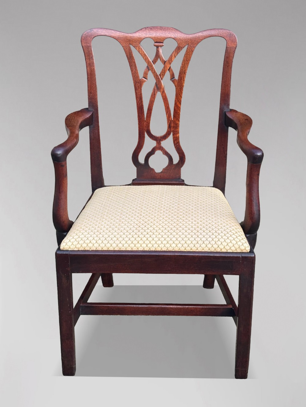 A set of eight George IV mahogany dining chairs with pierced fretwork splats and light cream upholstered drop-in seats. View V