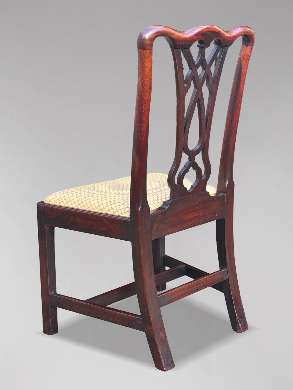 A set of eight George IV mahogany dining chairs with pierced fretwork splats and light cream upholstered drop-in seats. View VI