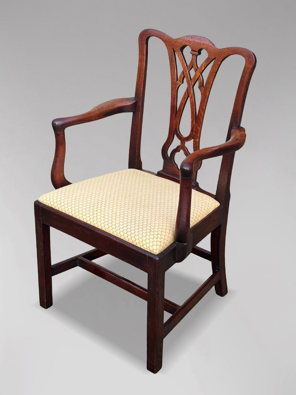 A set of eight George IV mahogany dining chairs with pierced fretwork splats and light cream upholstered drop-in seats. View IX
