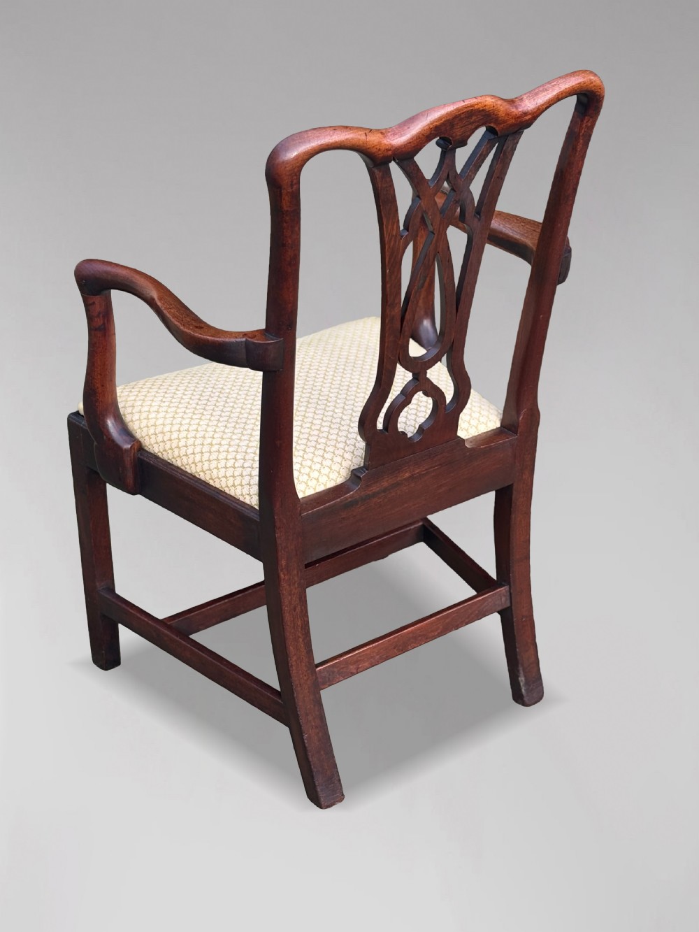 A set of eight George IV mahogany dining chairs with pierced fretwork splats and light cream upholstered drop-in seats. View X