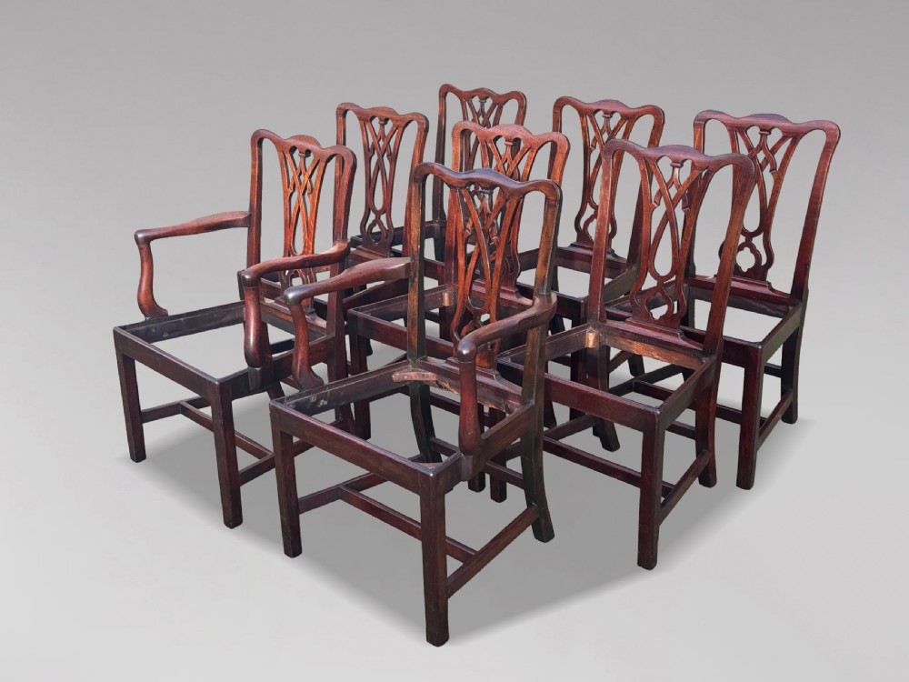 A set of eight George IV mahogany dining chairs with pierced fretwork splats and light cream upholstered drop-in seats. View XI