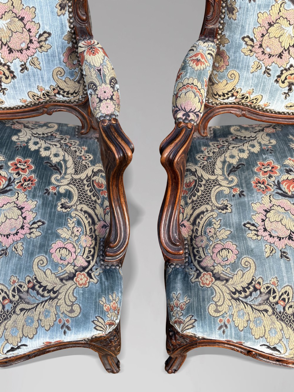 A set of four 19th-century French Louis XV style fauteuil armchairs featuring carved timber frames, cabriole legs, and blue floral upholstery. View VIII