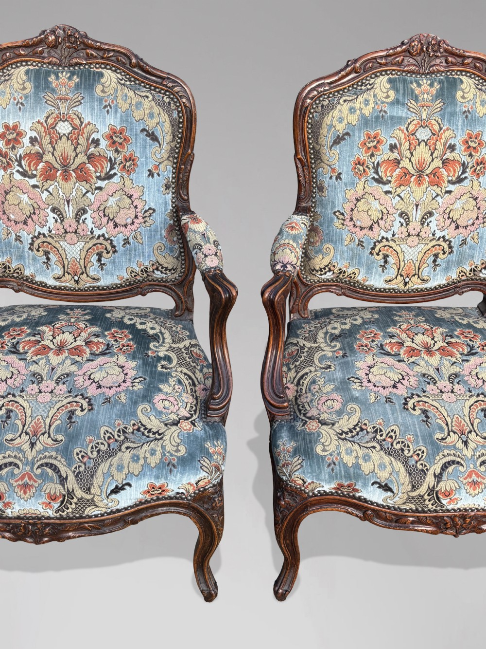 A set of four 19th-century French Louis XV style fauteuil armchairs featuring carved timber frames, cabriole legs, and blue floral upholstery. View XI