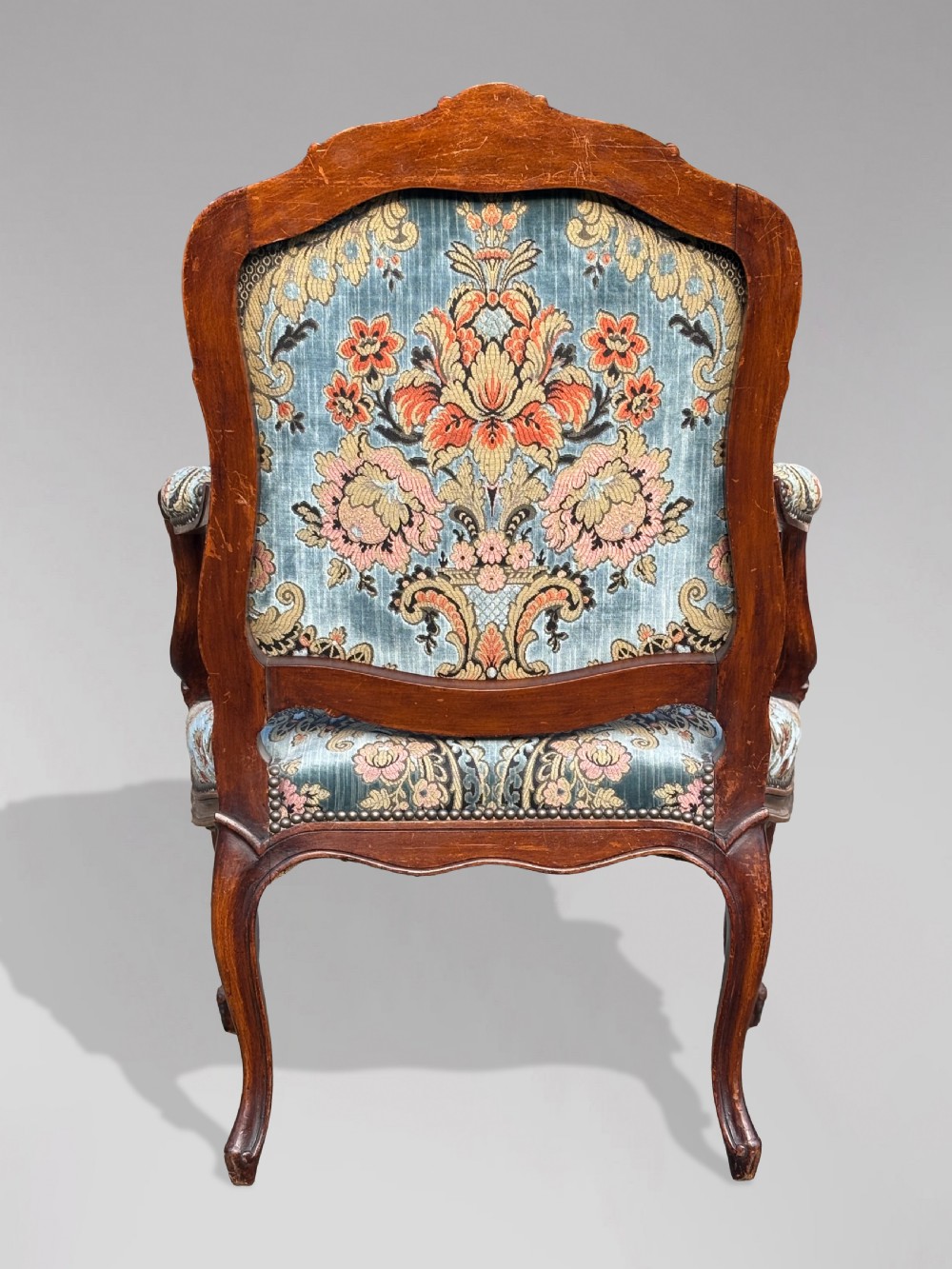 A set of four 19th-century French Louis XV style fauteuil armchairs featuring carved timber frames, cabriole legs, and blue floral upholstery. View XIV