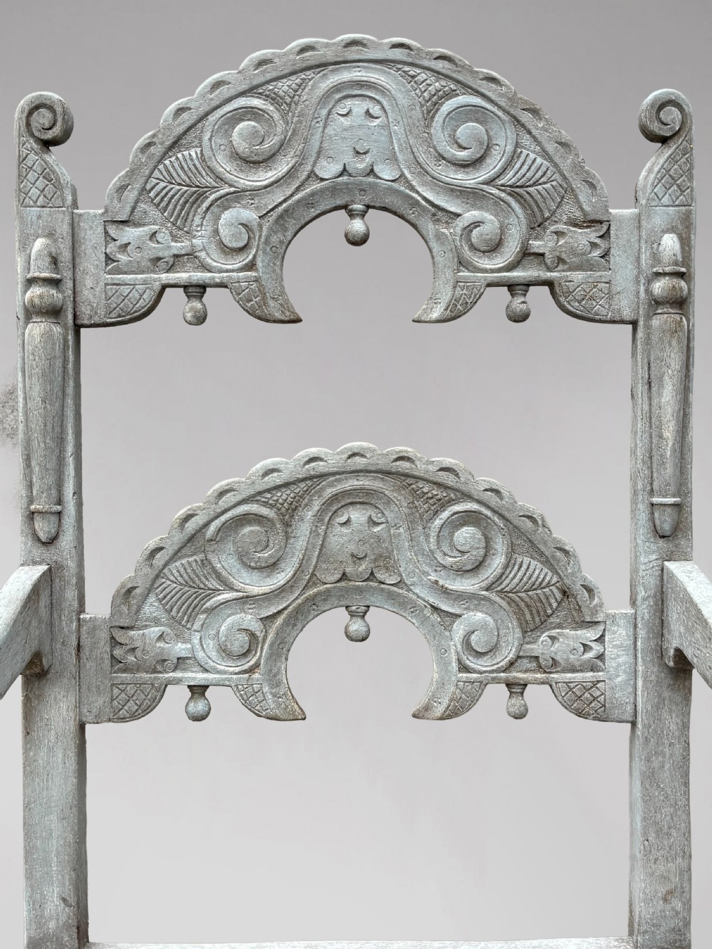 A set of eight light grey painted carved oak dining chairs featuring arched openwork backrests and turned legs. View II