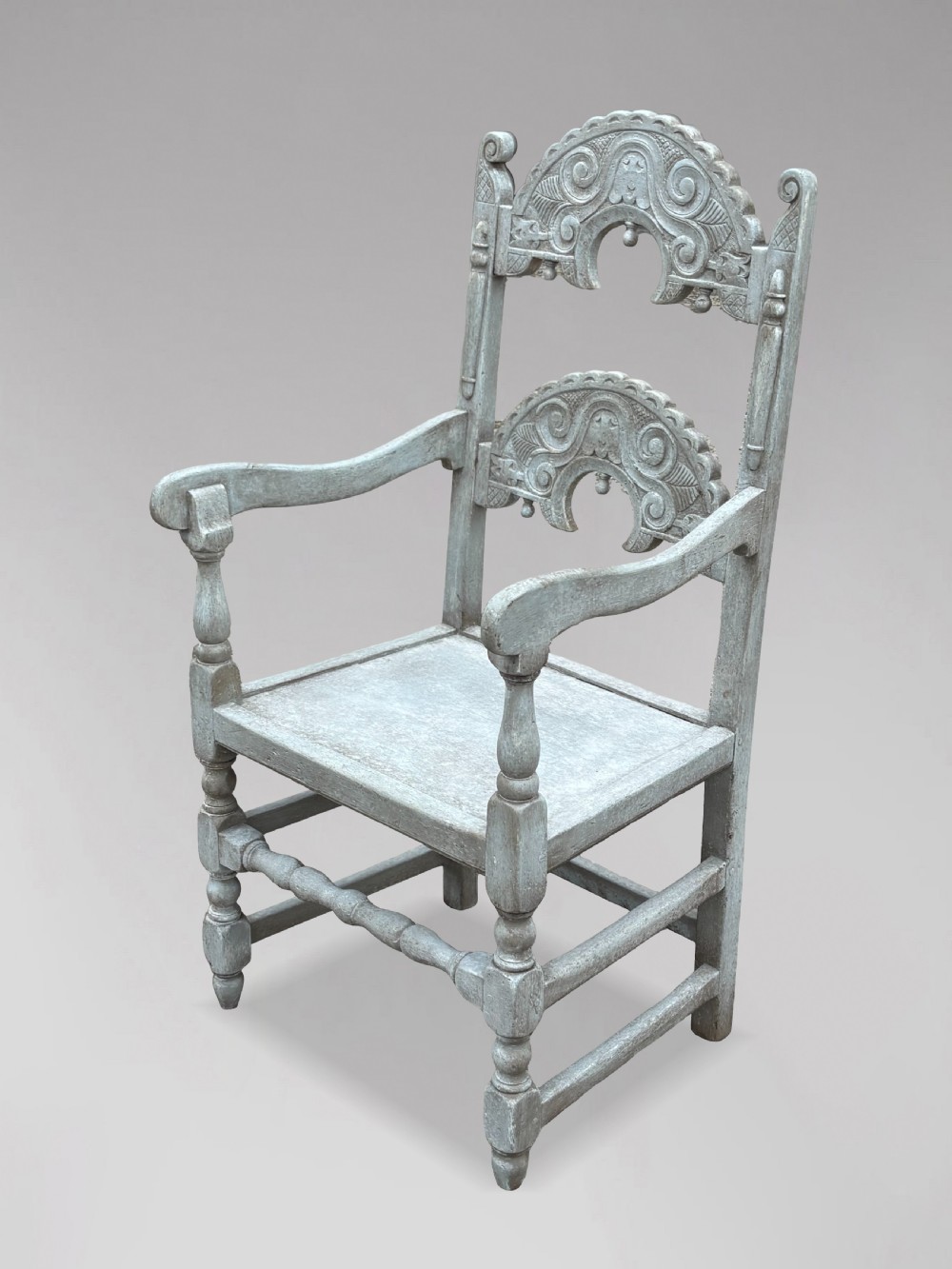 A set of eight light grey painted carved oak dining chairs featuring arched openwork backrests and turned legs. View IX