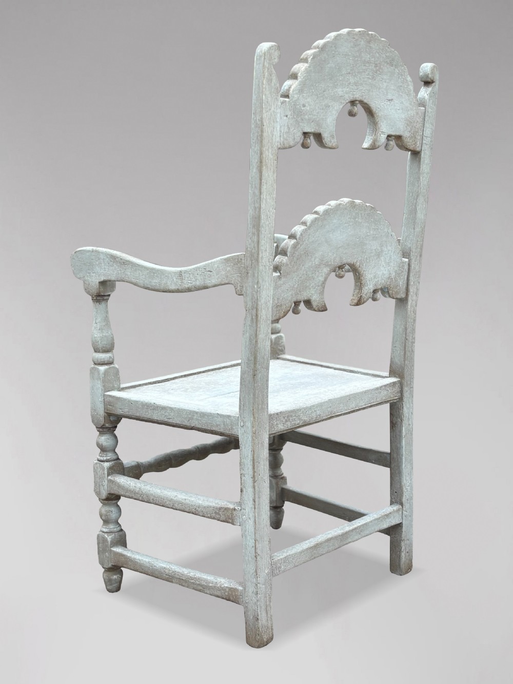 A set of eight light grey painted carved oak dining chairs featuring arched openwork backrests and turned legs. View X