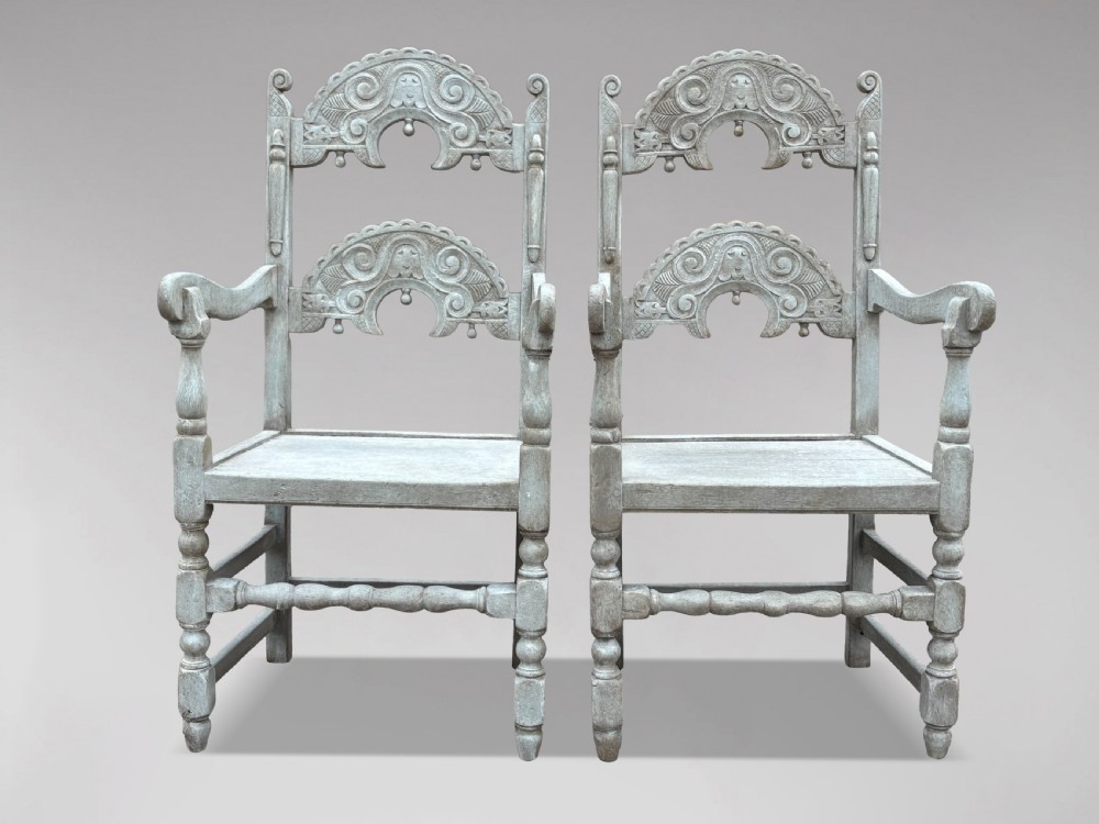 A set of eight light grey painted carved oak dining chairs featuring arched openwork backrests and turned legs. View XII