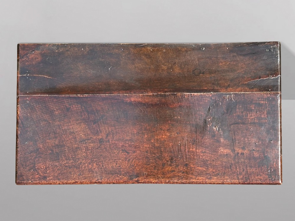 A 17th-century Charles II oak chest of drawers featuring geometric mitred mouldings, two short drawers over three long drawers, and brass teardrop handles. View III