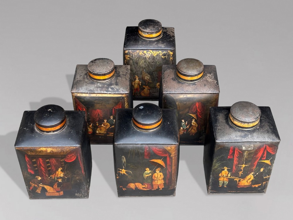 A set of three black rectangular antique toleware tea canisters hand-painted with detailed Chinoiserie figures and red drapery scenes. View VI