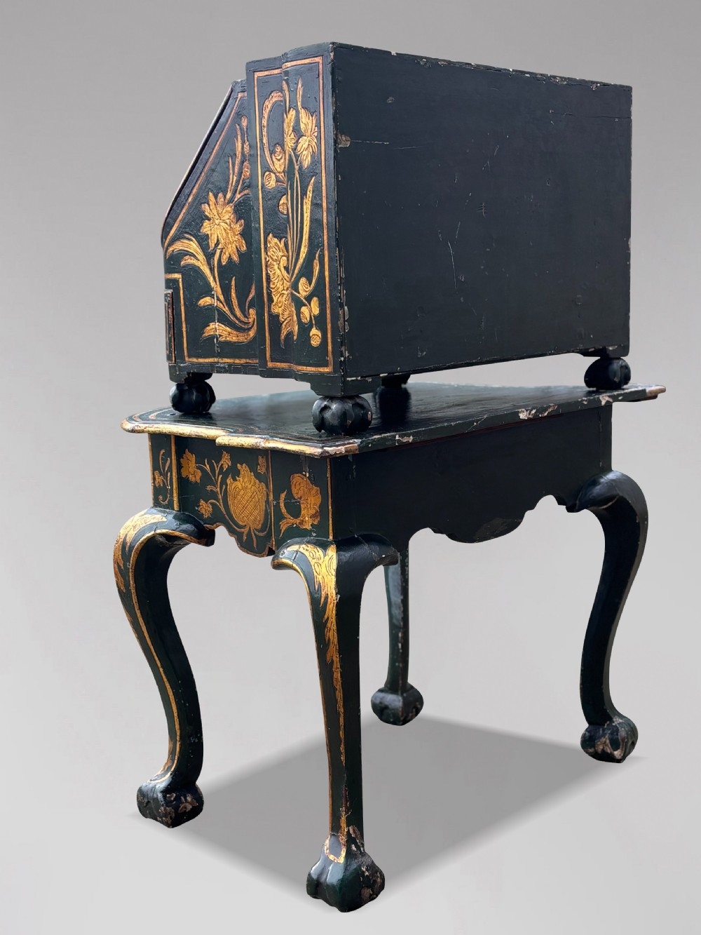 An 18th-century Venetian dark green lacquered travelling bureau with gilded floral scrollwork and fall-front writing flap resting on a matching cabriole-leg stand. View VI