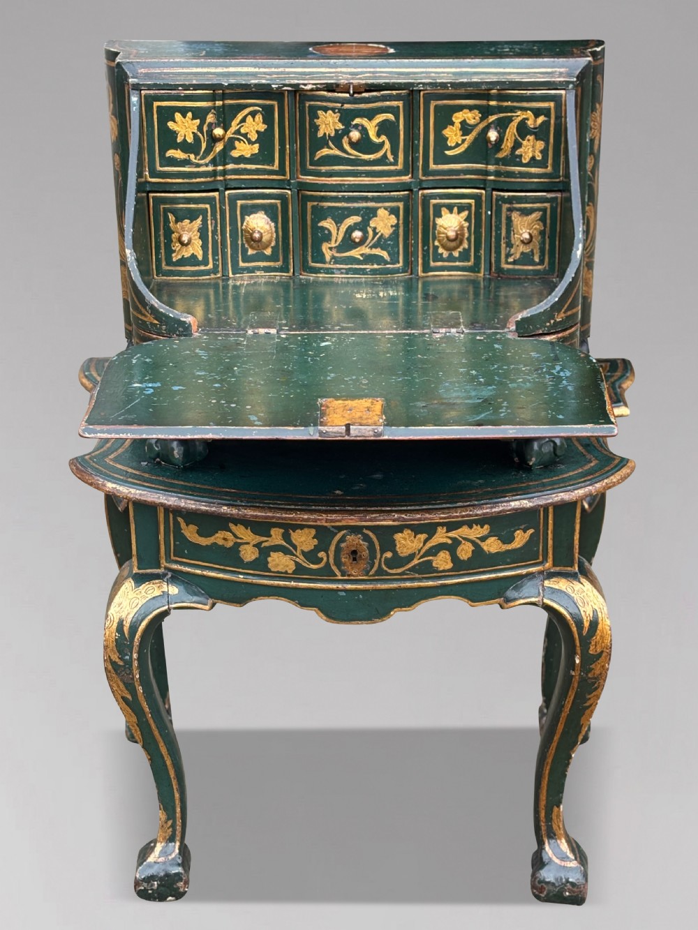An 18th-century Venetian dark green lacquered travelling bureau with gilded floral scrollwork and fall-front writing flap resting on a matching cabriole-leg stand. View VIII