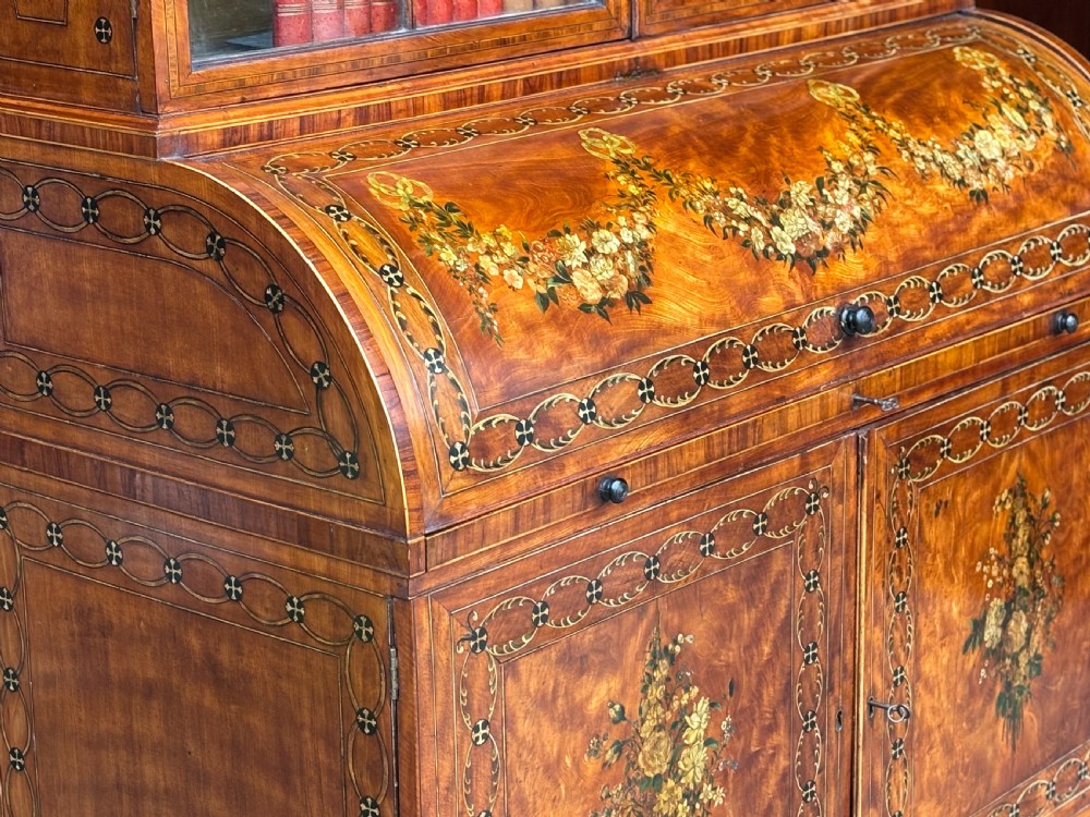 An 18th-century George III satinwood bureau bookcase featuring a glazed upper display cabinet above a cylinder writing section and two inlaid lower doors. View II