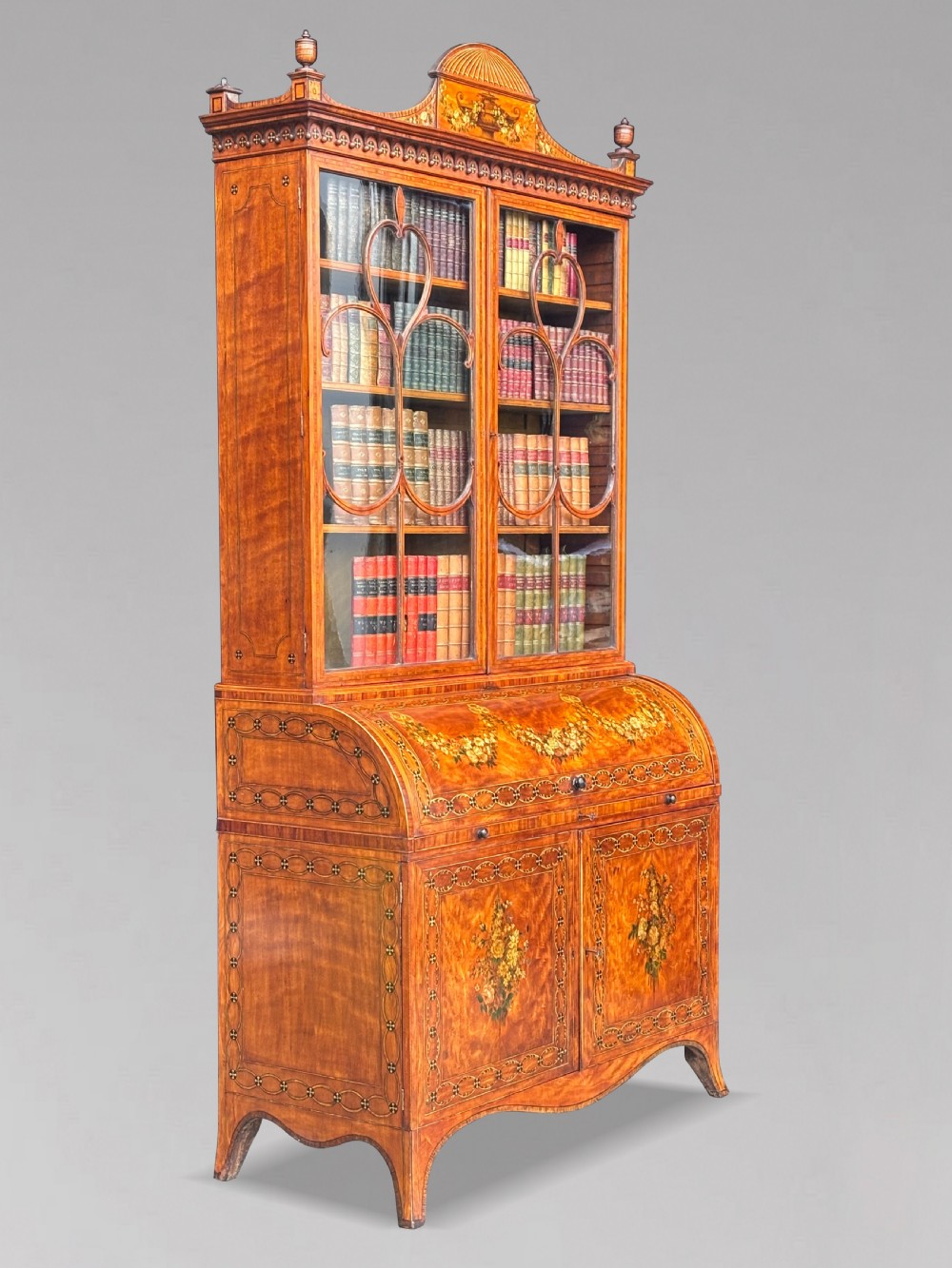 An 18th-century George III satinwood bureau bookcase featuring a glazed upper display cabinet above a cylinder writing section and two inlaid lower doors. View III
