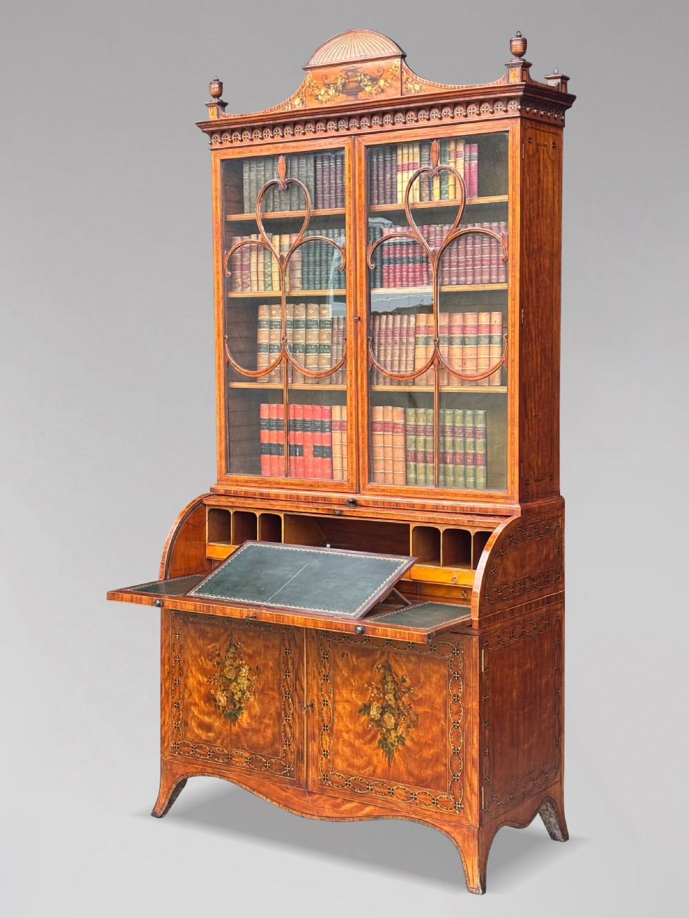 An 18th-century George III satinwood bureau bookcase featuring a glazed upper display cabinet above a cylinder writing section and two inlaid lower doors. View V