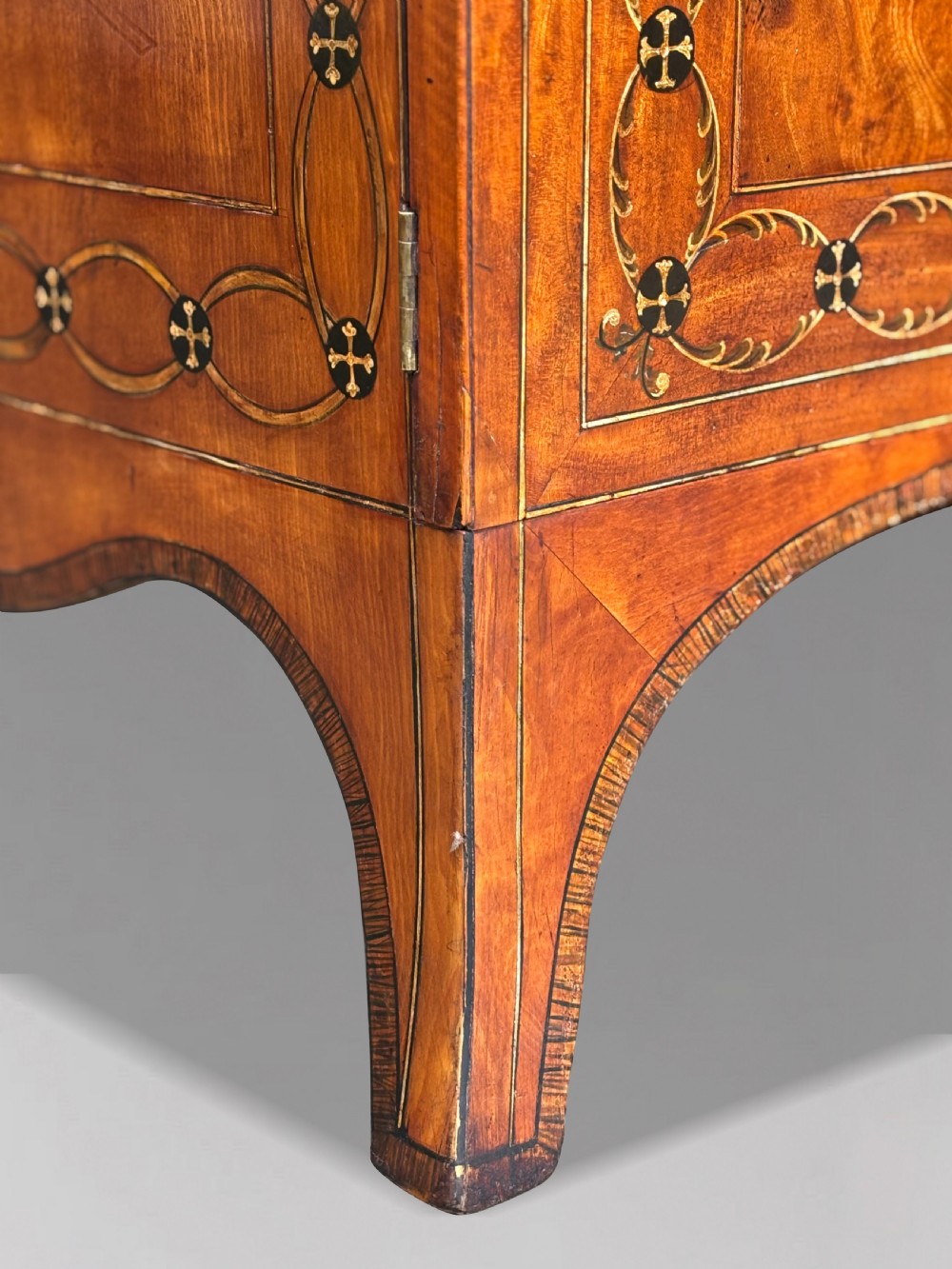 An 18th-century George III satinwood bureau bookcase featuring a glazed upper display cabinet above a cylinder writing section and two inlaid lower doors. View X