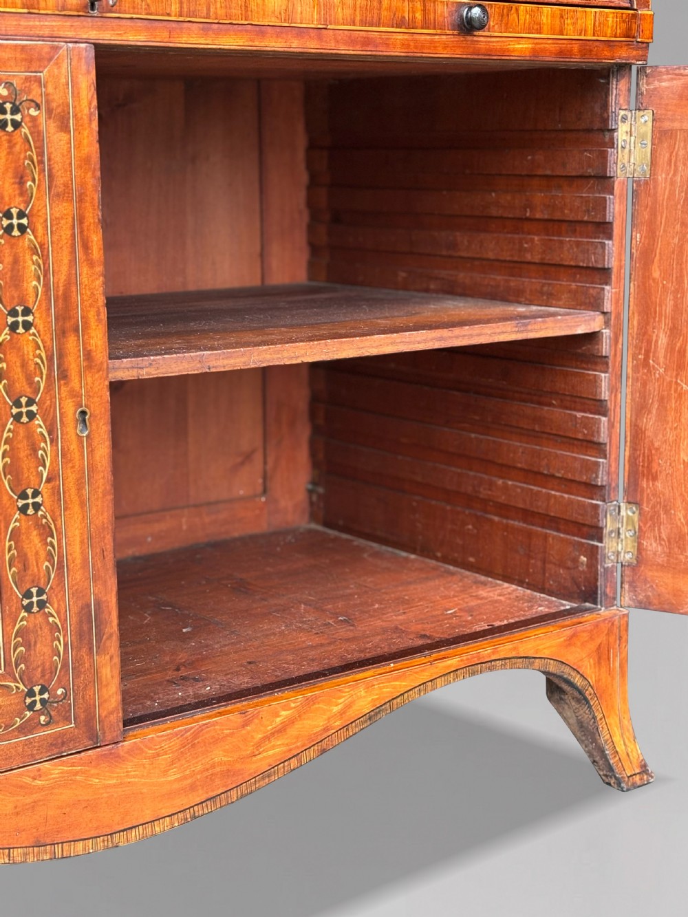 An 18th-century George III satinwood bureau bookcase featuring a glazed upper display cabinet above a cylinder writing section and two inlaid lower doors. View XI