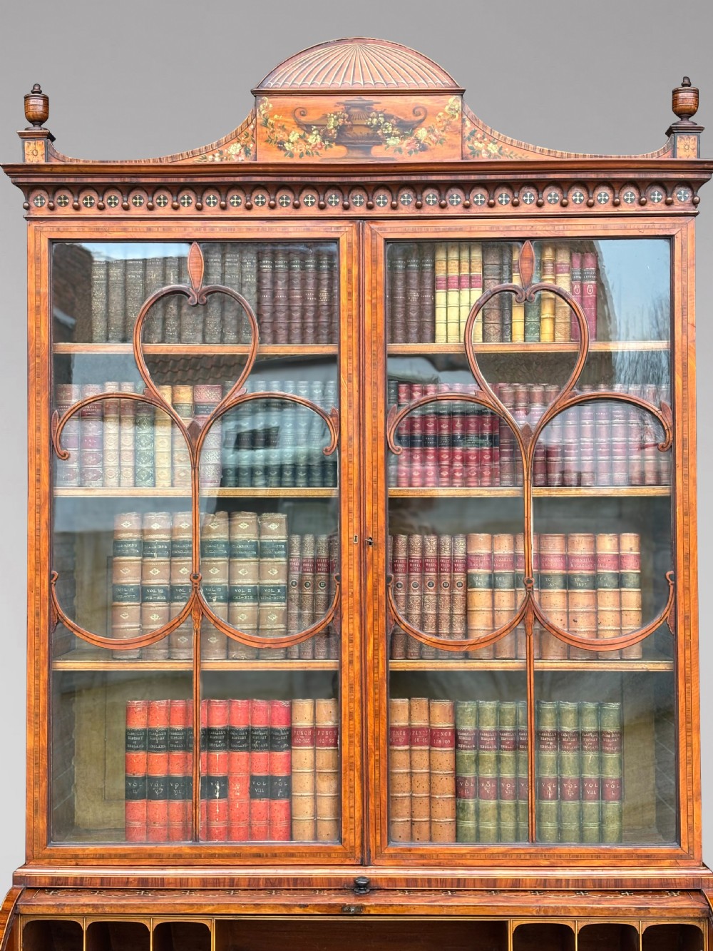An 18th-century George III satinwood bureau bookcase featuring a glazed upper display cabinet above a cylinder writing section and two inlaid lower doors. View XII