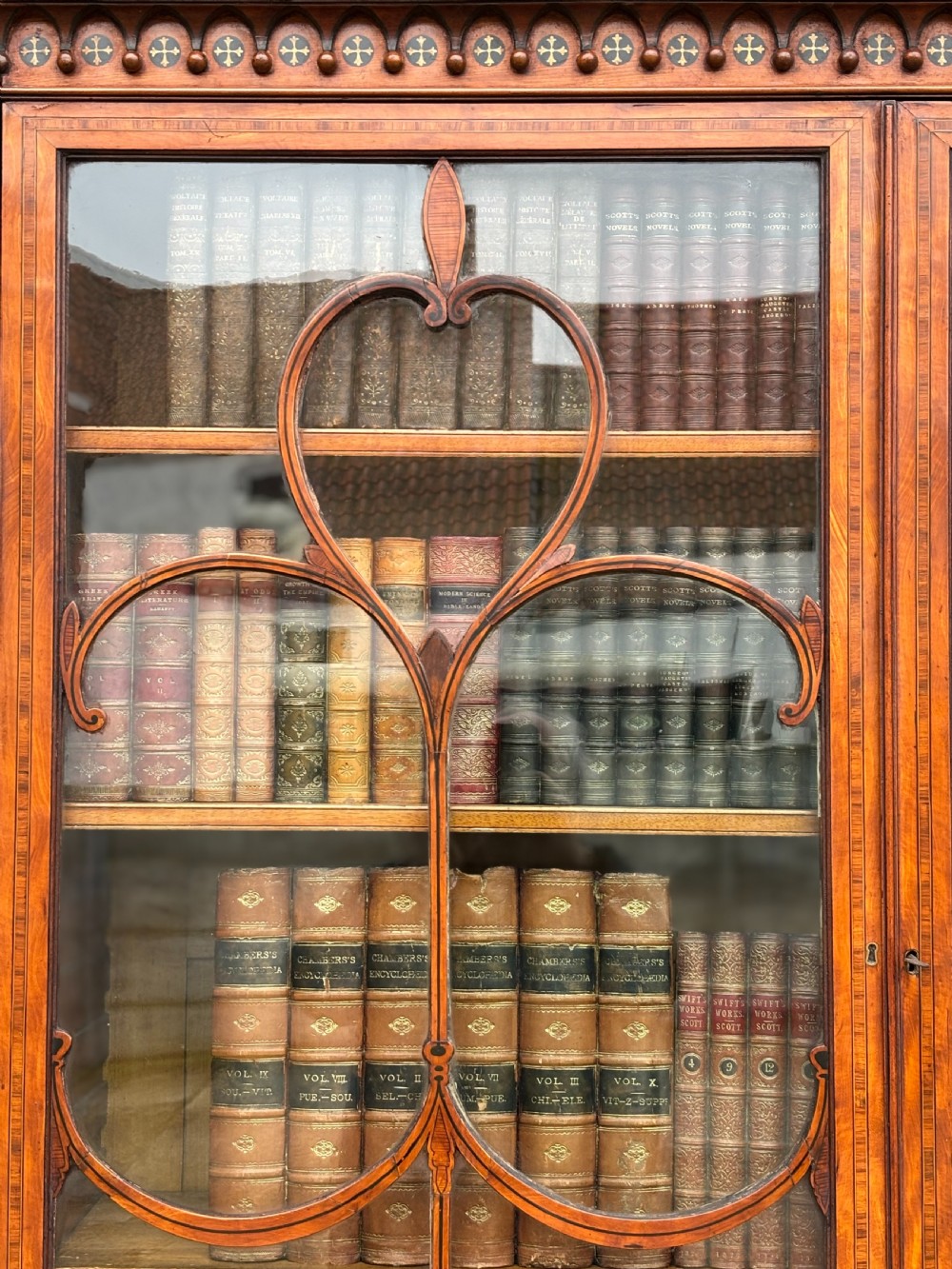 An 18th-century George III satinwood bureau bookcase featuring a glazed upper display cabinet above a cylinder writing section and two inlaid lower doors. View XIII