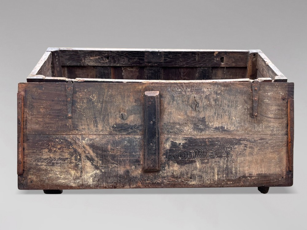 A seventeenth-century dark oak joined coffer with four carved panelled sections, a carved top rail dated 1678, and carved initials IMS. View III