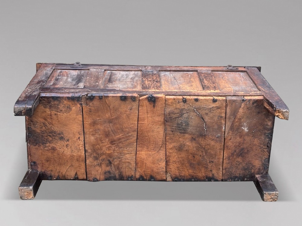 A seventeenth-century dark oak joined coffer with four carved panelled sections, a carved top rail dated 1678, and carved initials IMS. View IX
