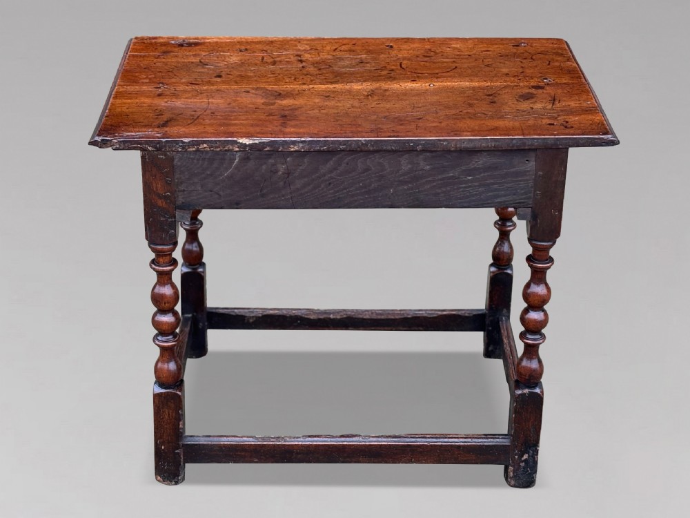 An early 18th-century George I period walnut lowboy side table featuring a single drawer with brass handles, turned legs, and a low box stretcher. View III