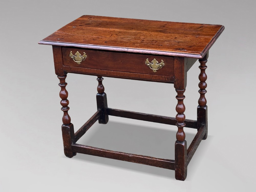 An early 18th-century George I period walnut lowboy side table featuring a single drawer with brass handles, turned legs, and a low box stretcher. View VIII