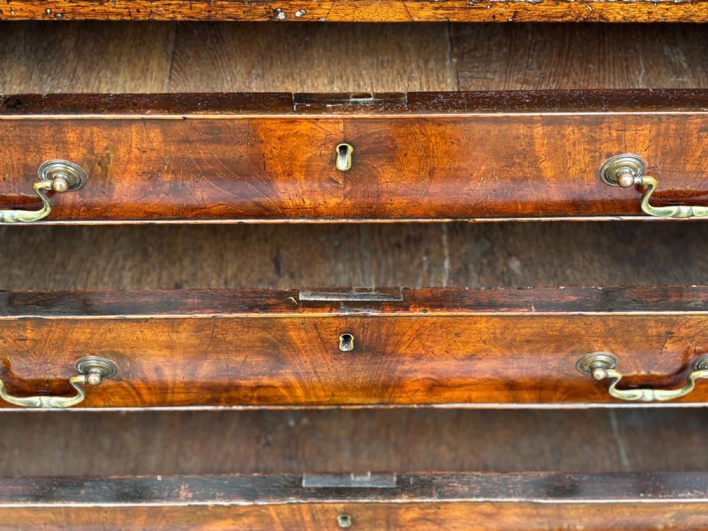 An 18th-century George III mahogany slant-front bureau featuring four graduated drawers with brass swan-neck handles and shaped bracket feet. View VI