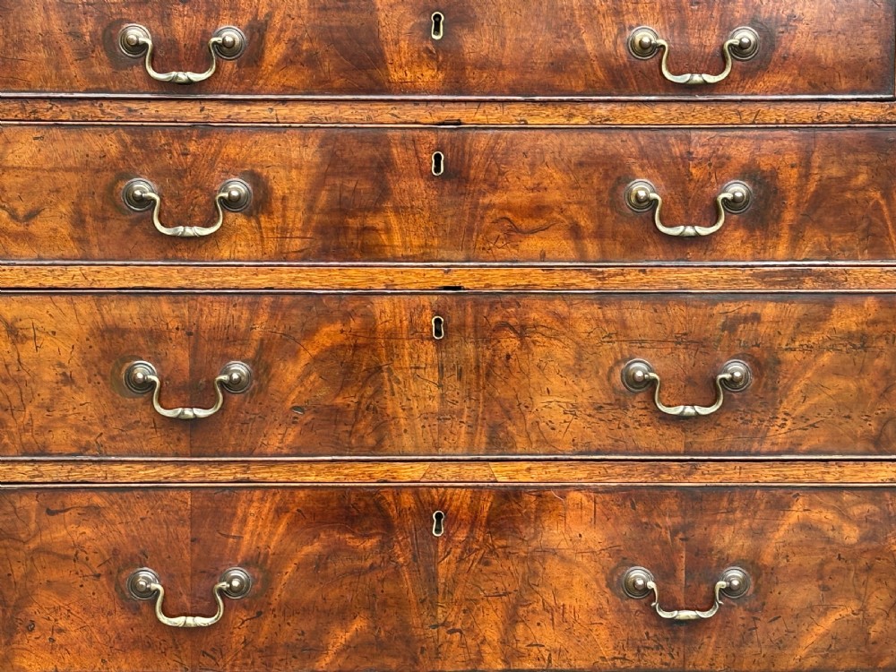 An 18th-century George III mahogany slant-front bureau featuring four graduated drawers with brass swan-neck handles and shaped bracket feet. View VII