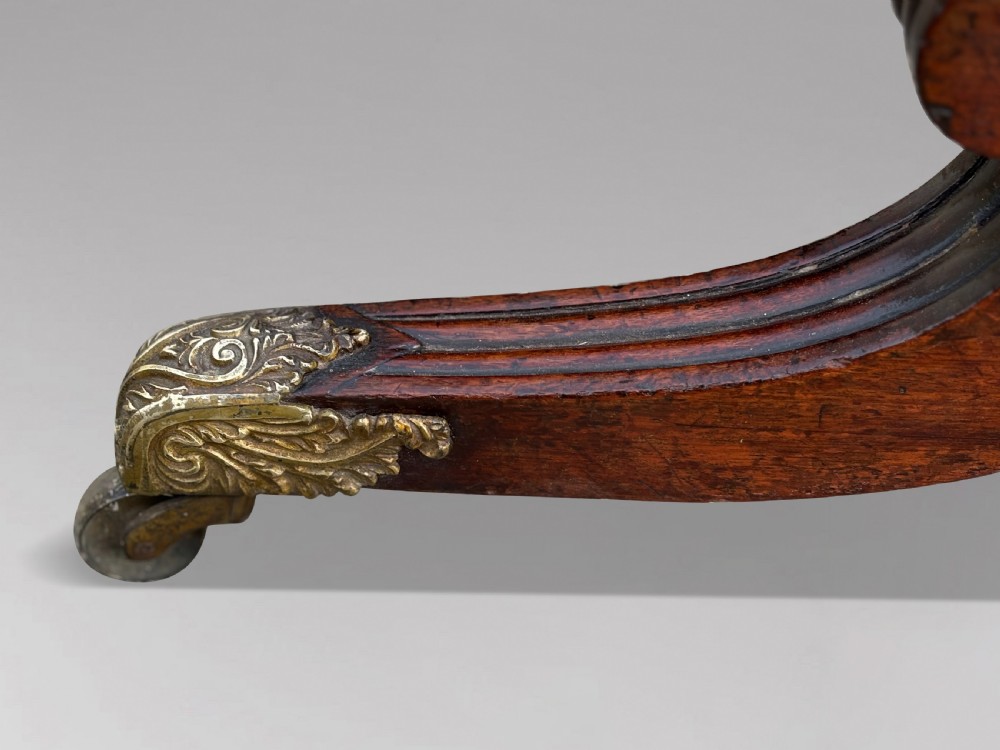 A 19th-century William IV mahogany cheval mirror featuring a rectangular swivel glass plate, dual brass candle sconces, turned stretchers, and splayed legs with brass claw feet on castors. View VII