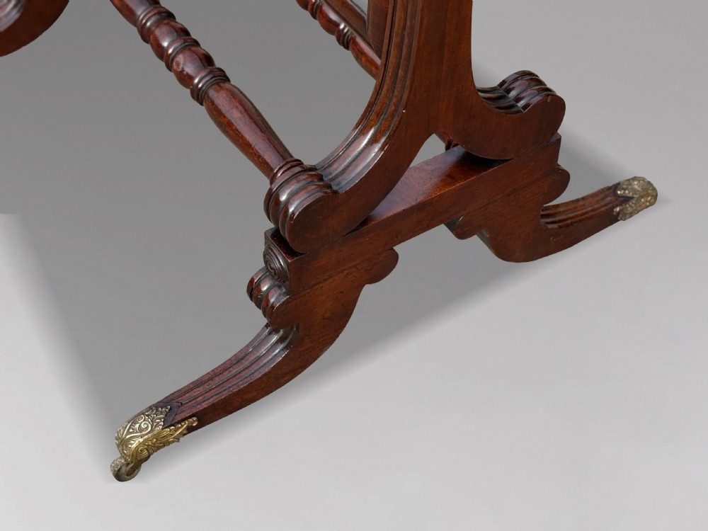 A 19th-century William IV mahogany cheval mirror featuring a rectangular swivel glass plate, dual brass candle sconces, turned stretchers, and splayed legs with brass claw feet on castors. View IX