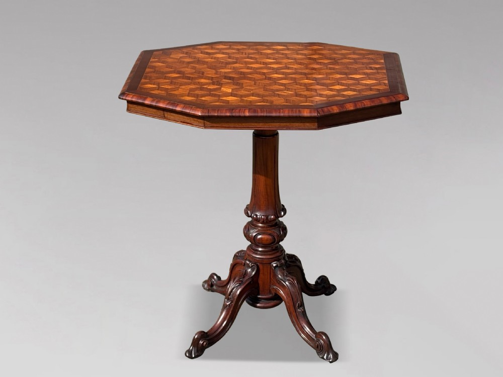 A Victorian walnut tilt-top table featuring an octagonal top decorated with a geometric parquetry pattern, supported by a carved pedestal and tripod legs. View II