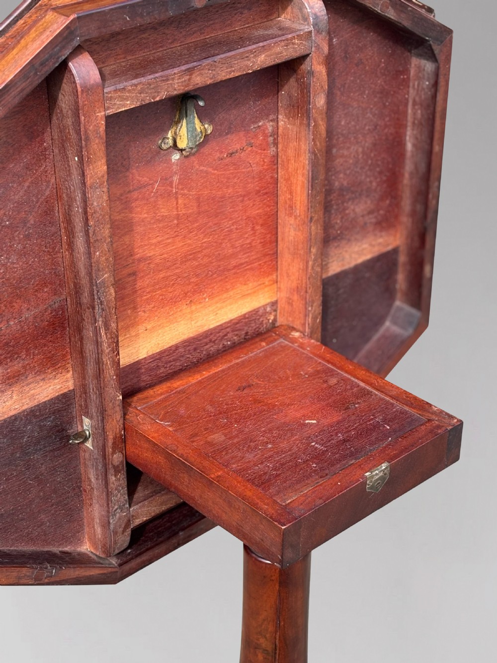 A Victorian walnut tilt-top table featuring an octagonal top decorated with a geometric parquetry pattern, supported by a carved pedestal and tripod legs. View VI