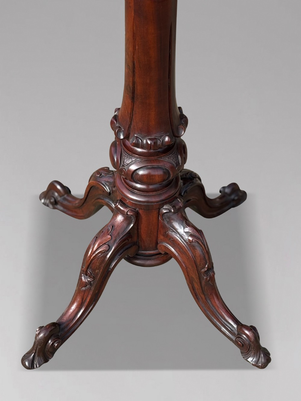 A Victorian walnut tilt-top table featuring an octagonal top decorated with a geometric parquetry pattern, supported by a carved pedestal and tripod legs. View IX