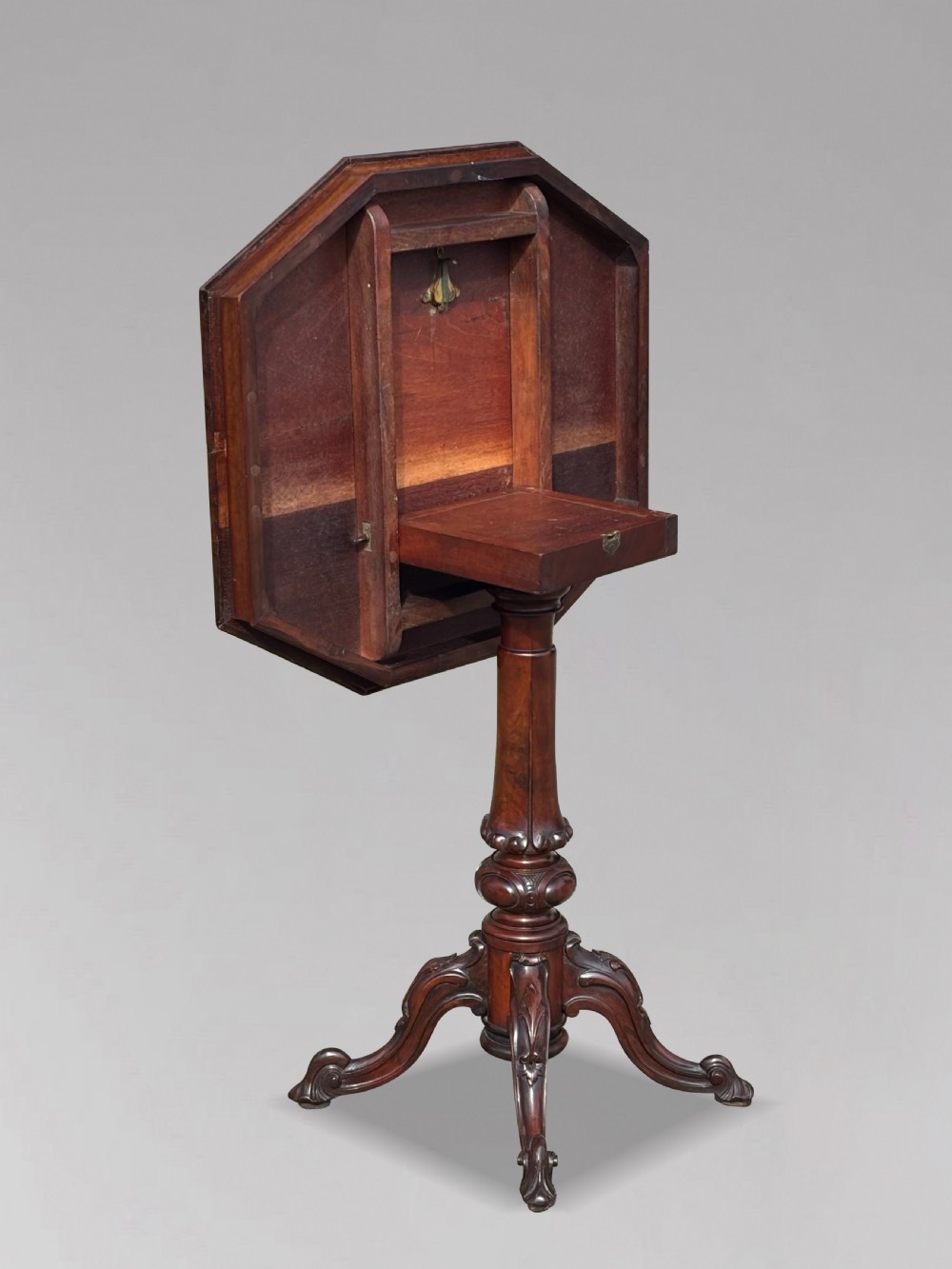 A Victorian walnut tilt-top table featuring an octagonal top decorated with a geometric parquetry pattern, supported by a carved pedestal and tripod legs. View XI
