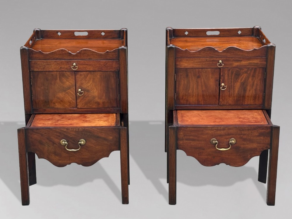 A pair of 18th-century George III mahogany bedside cabinets featuring tray tops with pierced handles, twin cupboard doors, and pull-out lower drawers with brass drop handles. View II