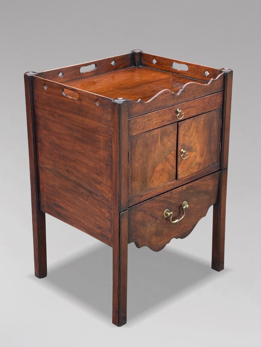 A pair of 18th-century George III mahogany bedside cabinets featuring tray tops with pierced handles, twin cupboard doors, and pull-out lower drawers with brass drop handles. View XI