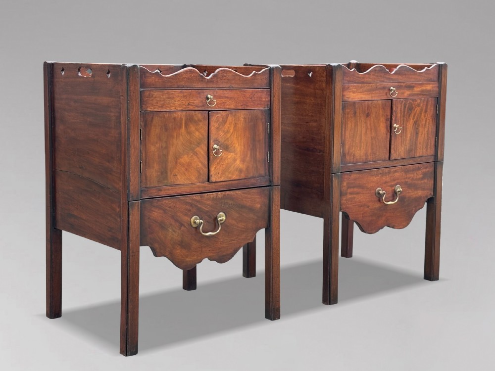 A pair of 18th-century George III mahogany bedside cabinets featuring tray tops with pierced handles, twin cupboard doors, and pull-out lower drawers with brass drop handles. View XII