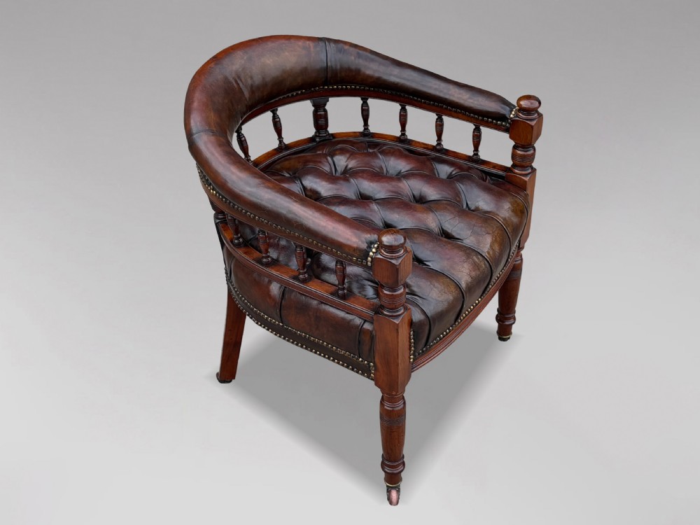 19th-century mahogany captains desk armchair upholstered in button-tufted brown leather with brass stud detail and turned spindles. View IX