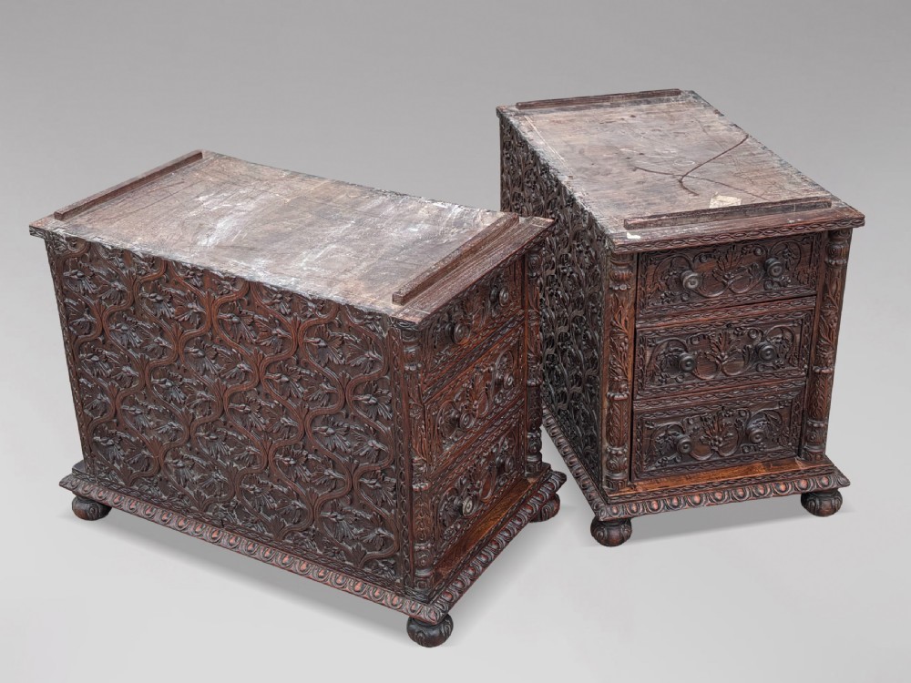 Nineteenth-century Anglo-Indian carved padauk partners desk featuring intricate foliate relief carvings across the pedestal drawers and side panels on turned bun feet. View VII